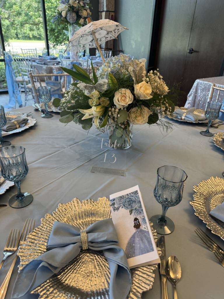 Blue bow napkin, silver charger and white floral centerpiece