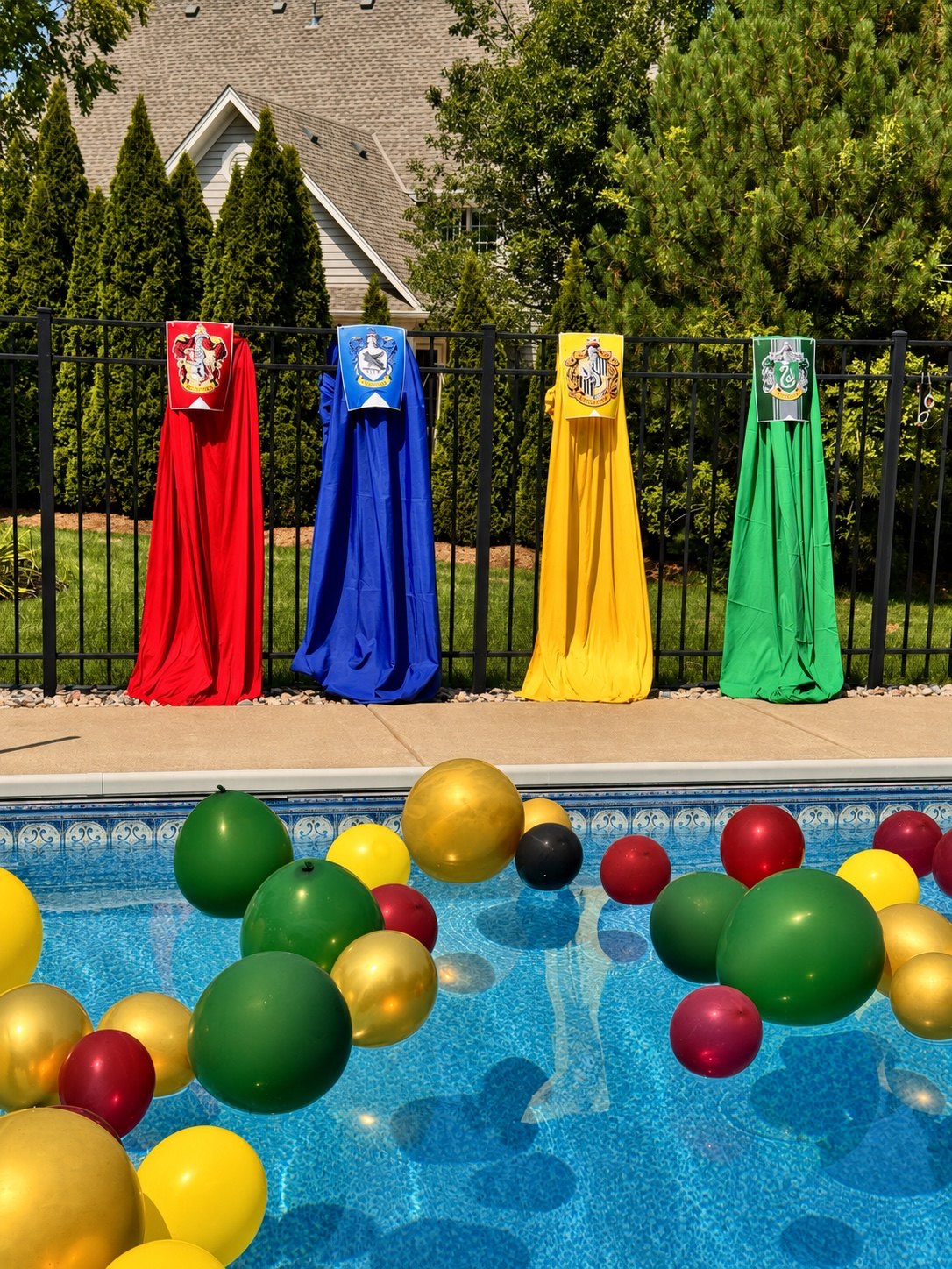 Colorful floating pool balloons and four themed fabric displays