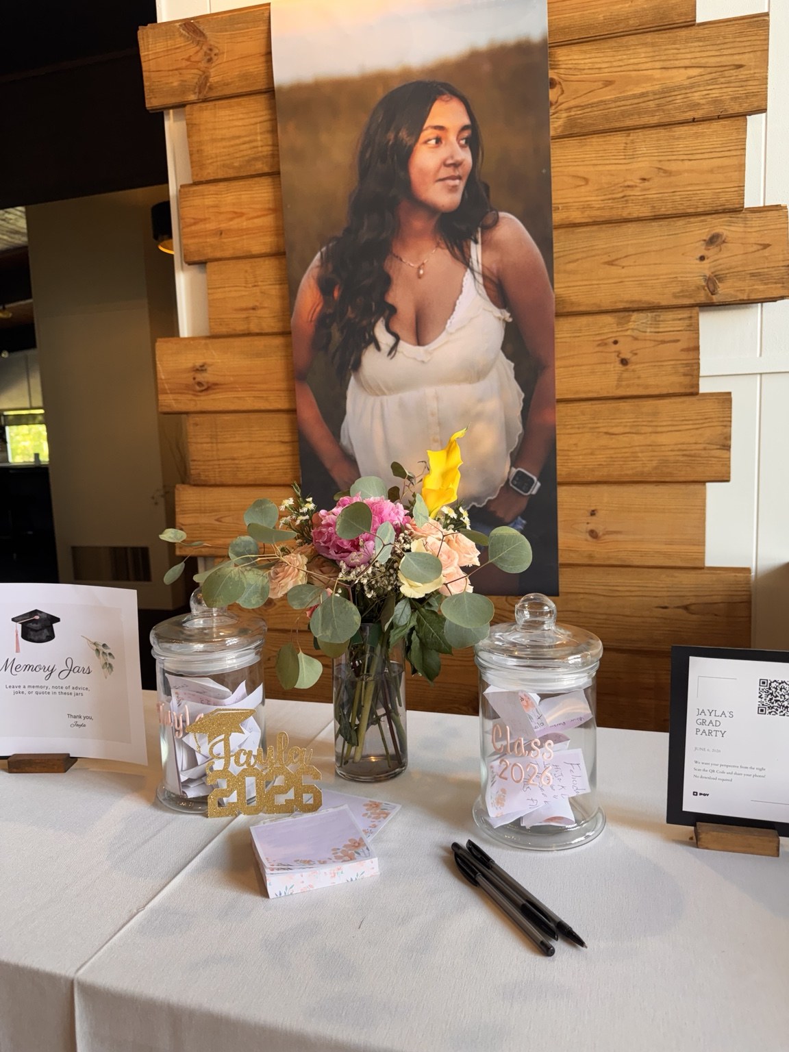 Personalized portrait display with bud vase flowers and coordinated table details