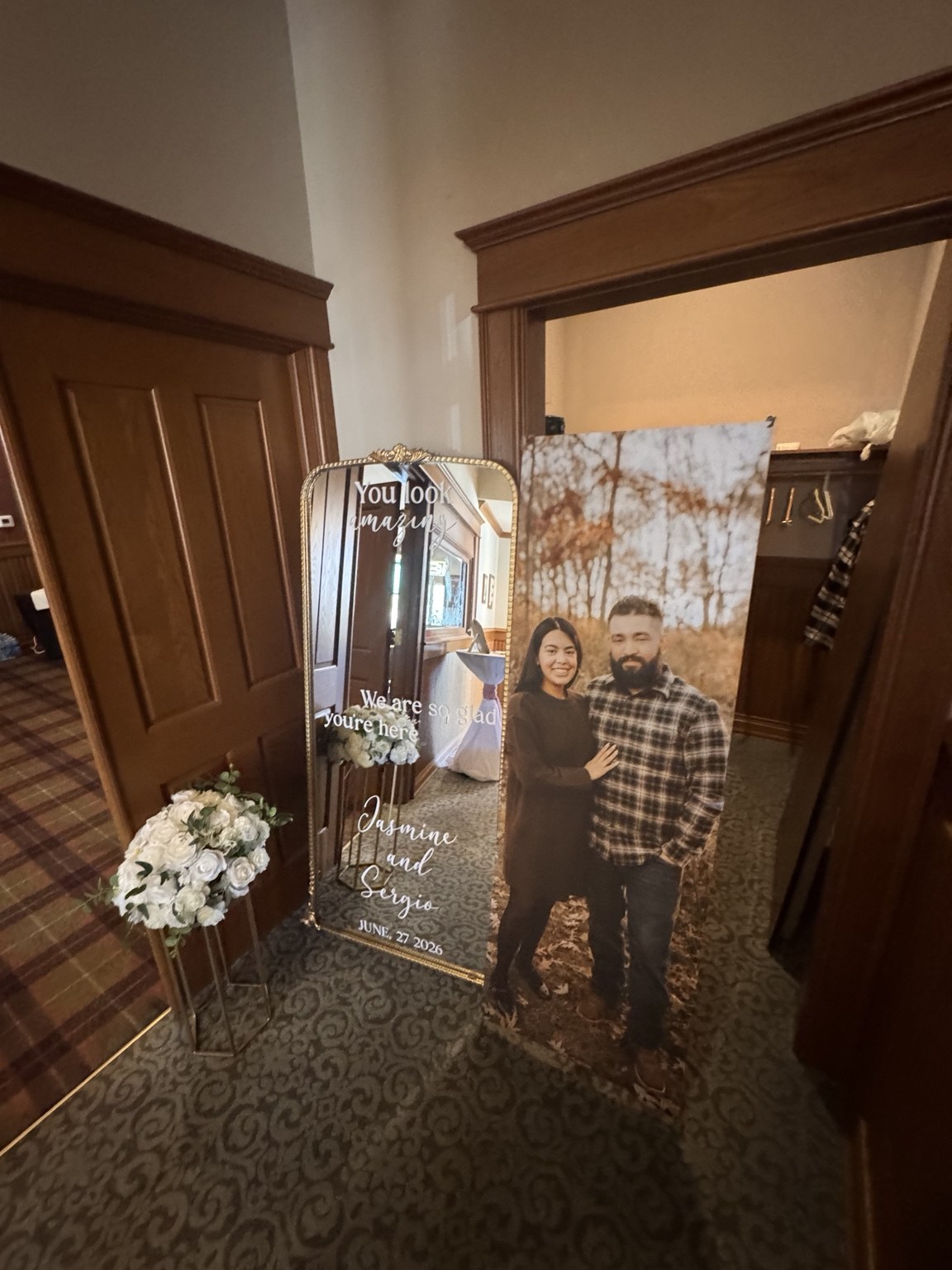Wedding welcome mirror and personalized couple portrait with floral accents