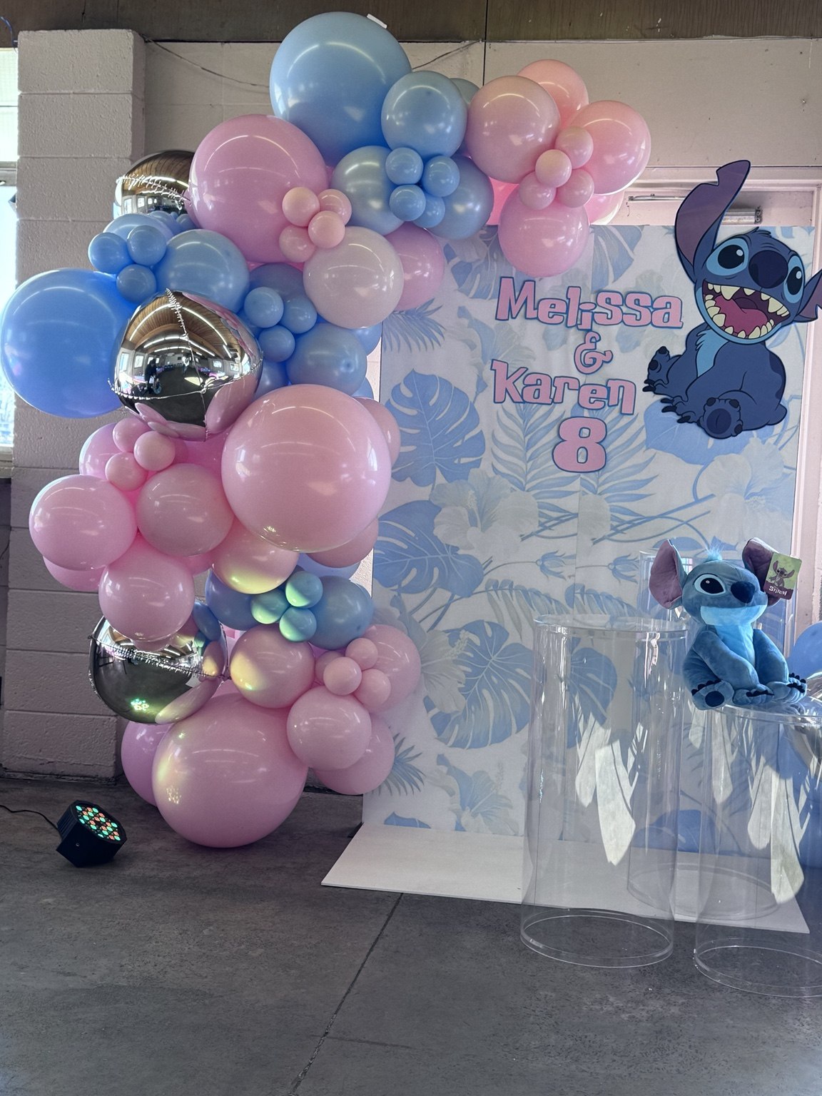 Pink & blue balloon backdrop with pink and blue balloons and a personalized Stitch theme