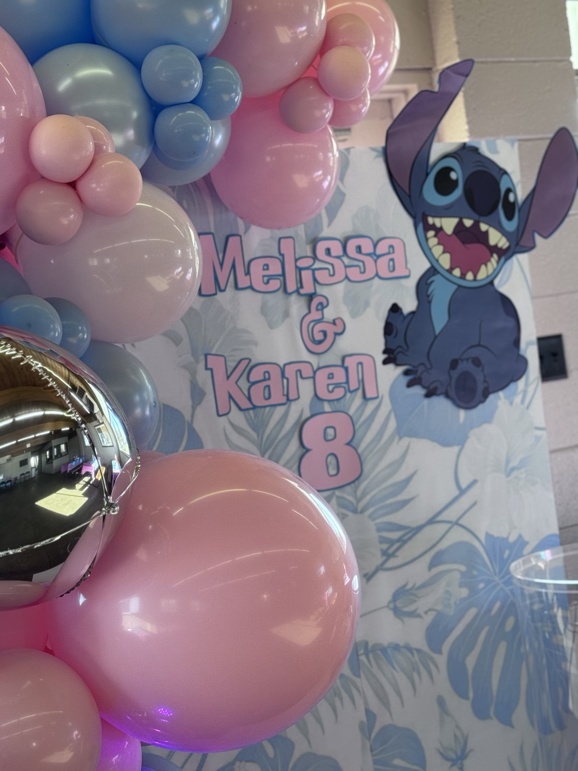 Stitch backdrop close-up with pink and blue balloons and a personalized Stitch theme
